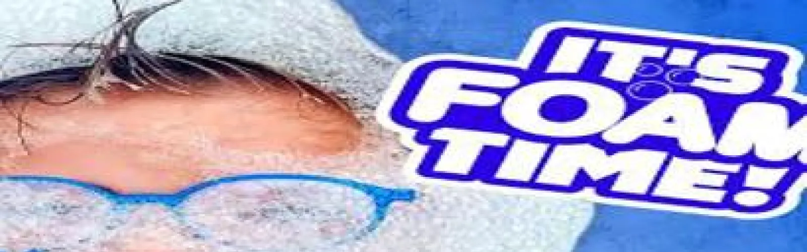 A boy's head. All you can see are his glasses and hair. The rest is surrounded by foam and beside the image is the words It's Foam Time.